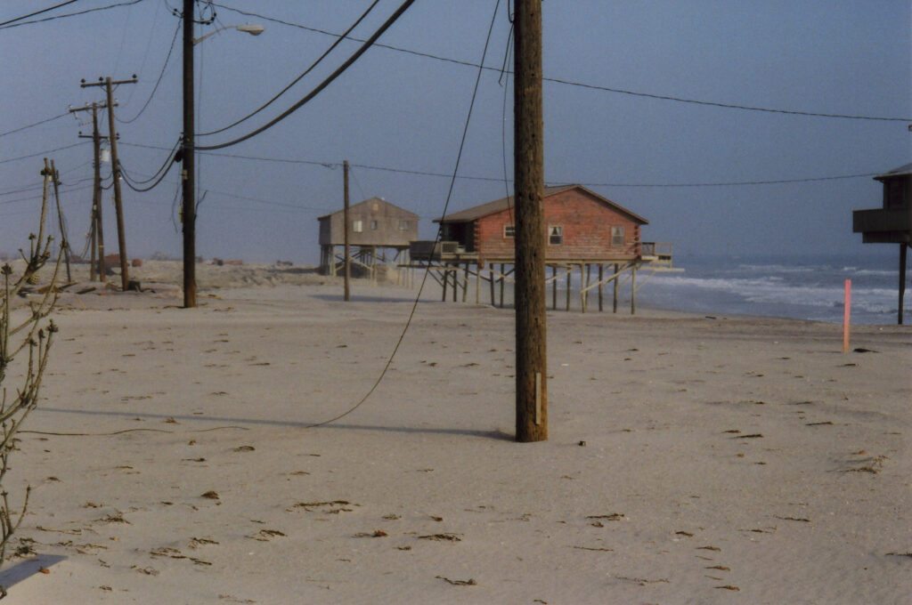 Exposed pilings and telephone poles on Dune Road